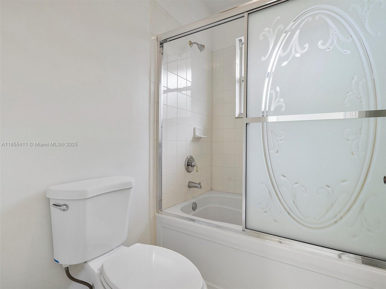 4964 Southwest 128th Avenue Miramar, FL 33027 - Photo 25 of 38 a bathroom with a granite countertop bathtub shower and toilet