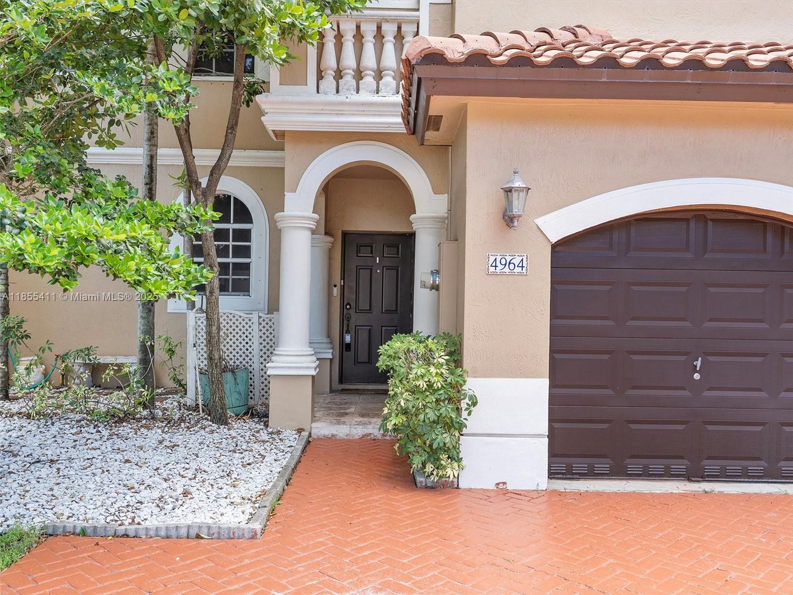 4964 Southwest 128th Avenue Miramar, FL 33027 - Photo 3 of 38 a front view of a house with a yard