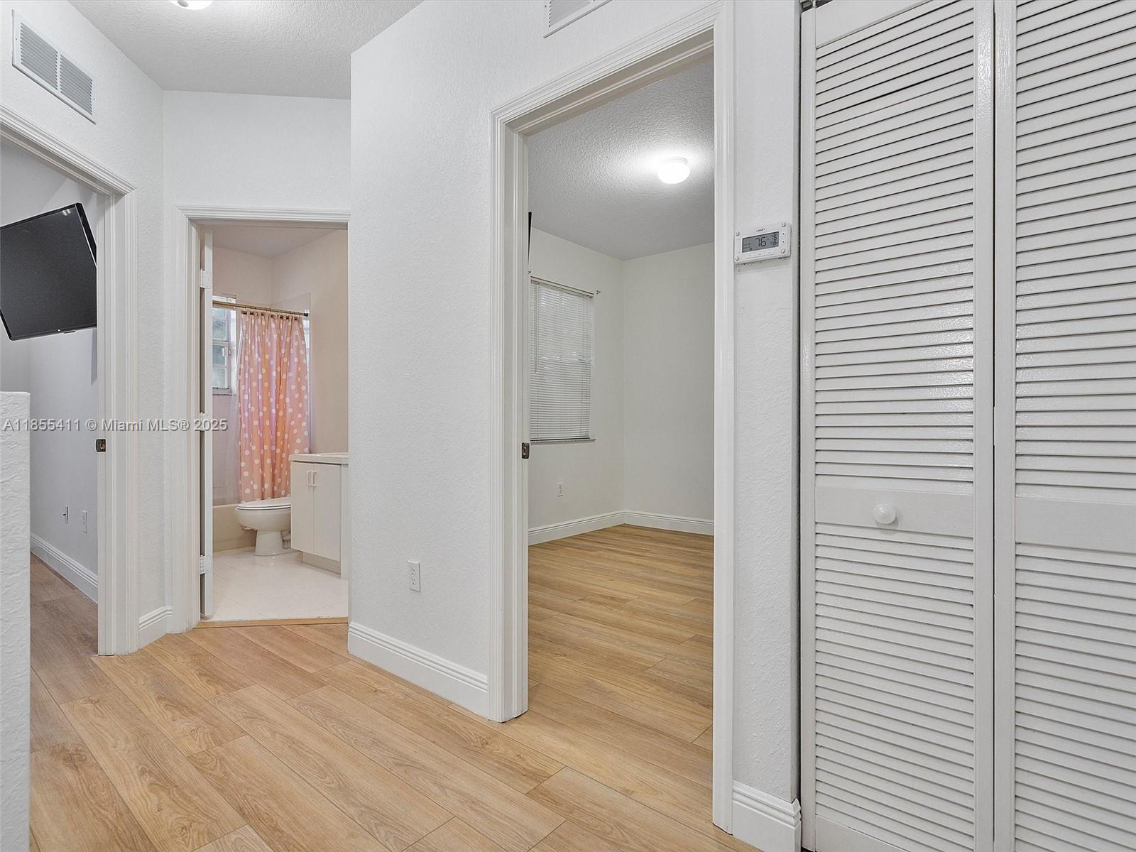 4964 Southwest 128th Avenue Miramar, FL 33027 - Photo 31 of 38 a view of hallway with wooden floor