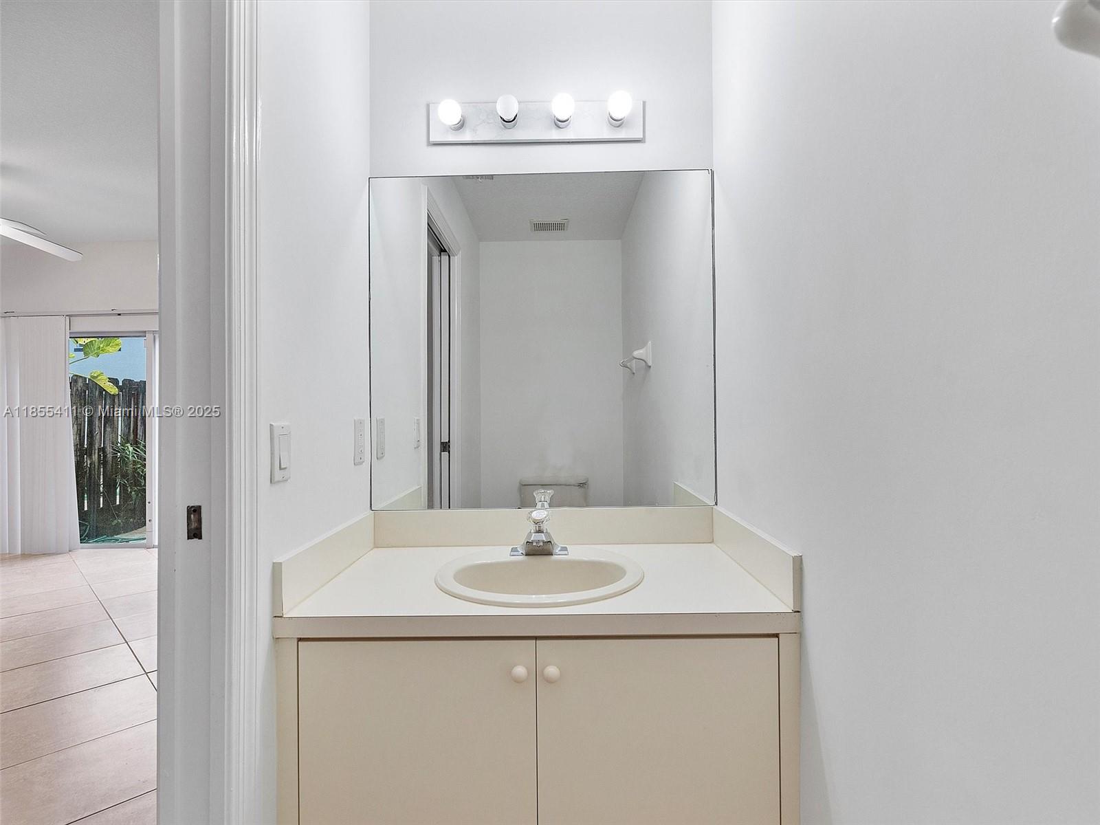 4964 Southwest 128th Avenue Miramar, FL 33027 - Photo 33 of 38 a bathroom with a sink and a mirror