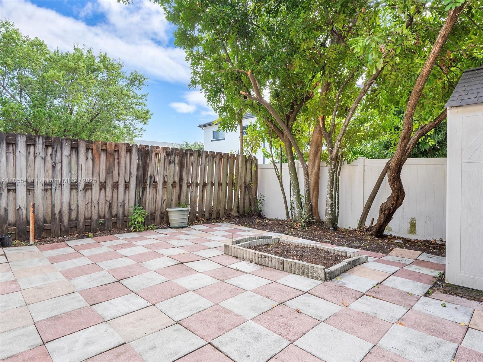 4964 Southwest 128th Avenue Miramar, FL 33027 - Photo 36 of 38 a view of wooden fence and trees