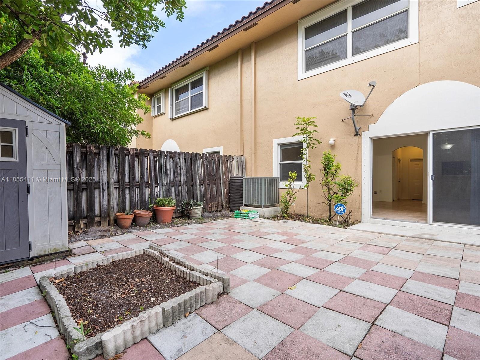 4964 Southwest 128th Avenue Miramar, FL 33027 - Photo 37 of 38 a backyard of a house with barbeque oven table and chairs