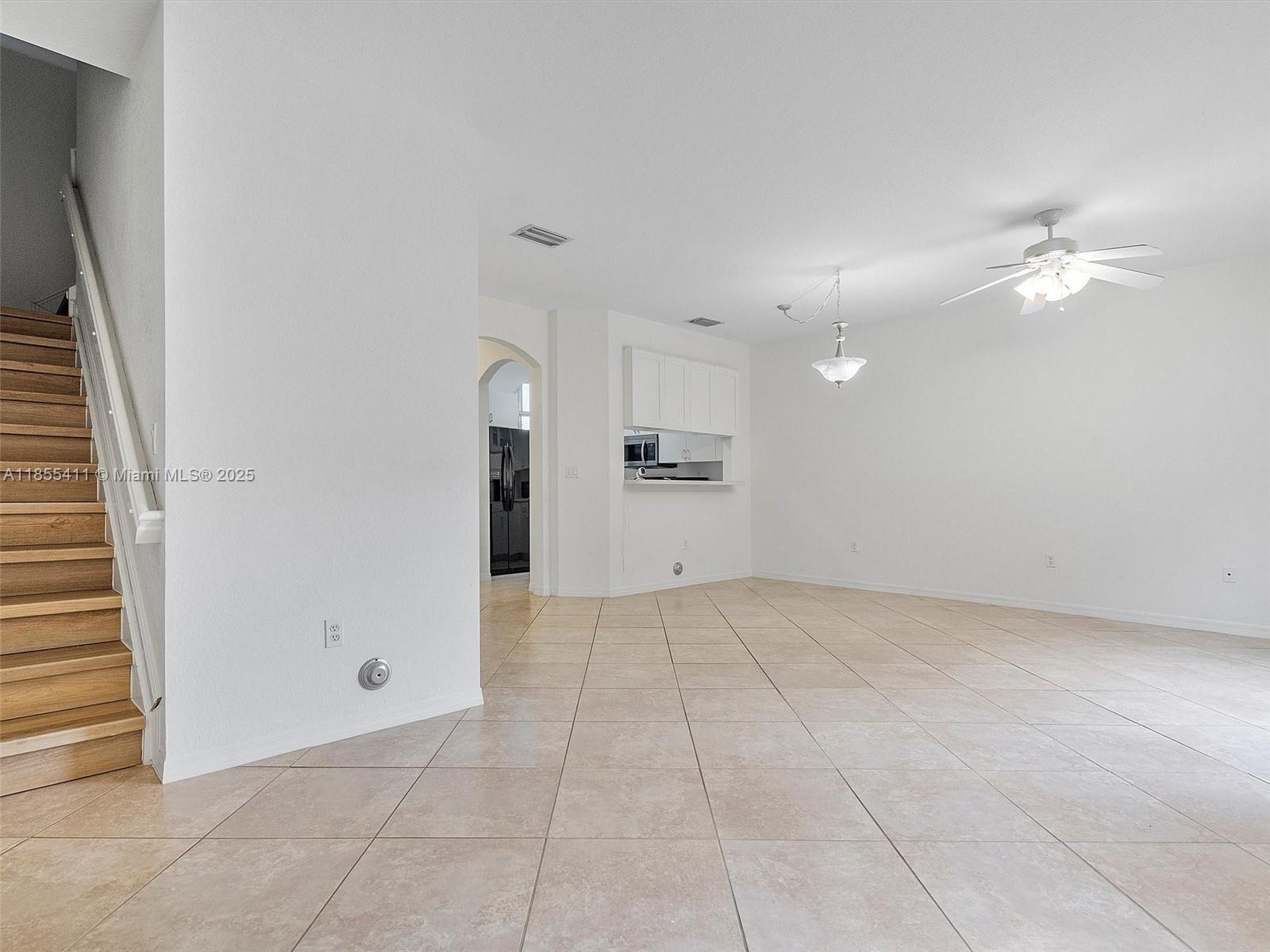 4964 Southwest 128th Avenue Miramar, FL 33027 - Photo 6 of 38 a view of an empty room with a kitchen