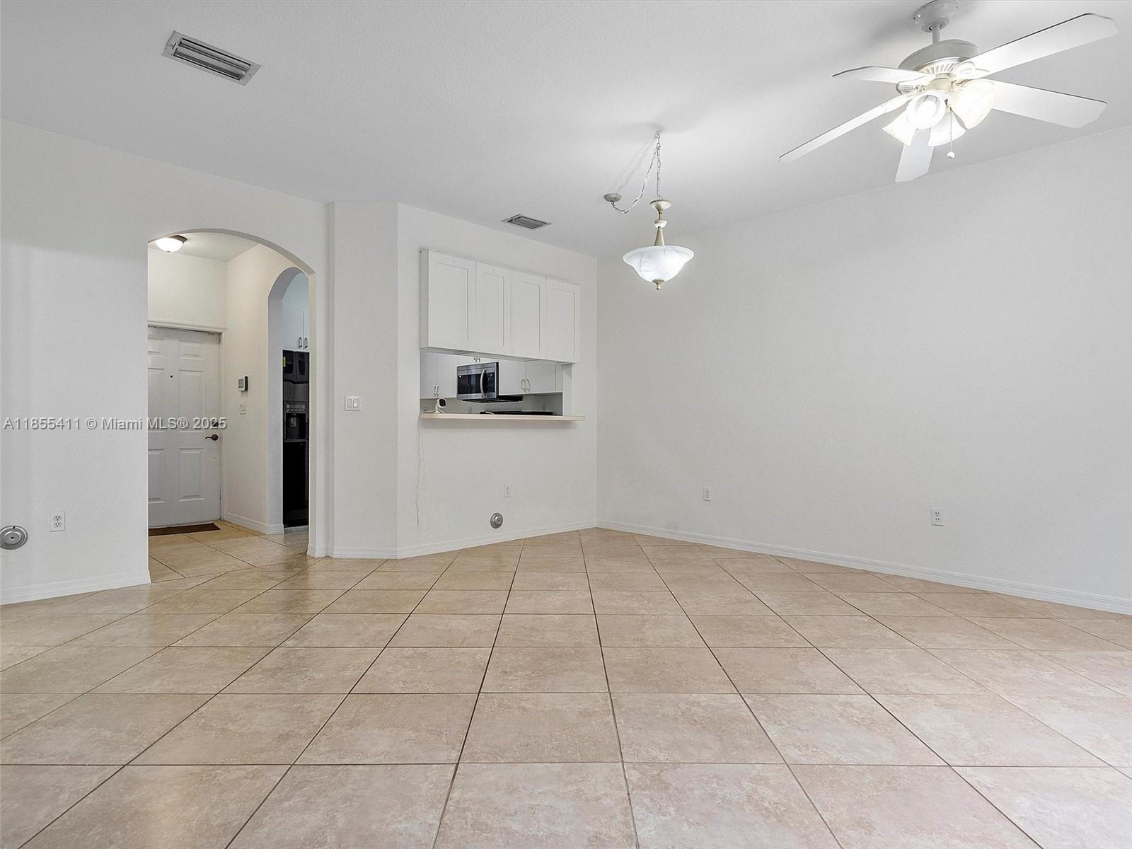 4964 Southwest 128th Avenue Miramar, FL 33027 - Photo 8 of 38 an empty room with fan and a chandelier fan