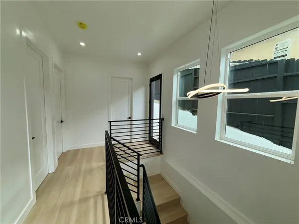 a view of entryway and hall with wooden floor