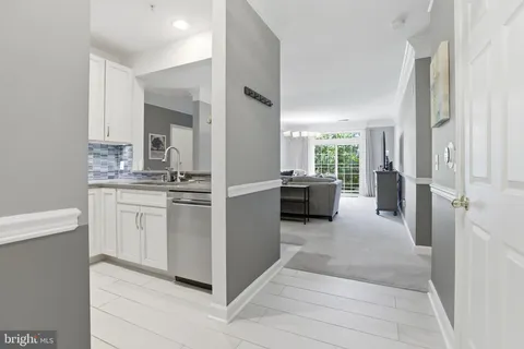 a kitchen with white cabinets and white appliances