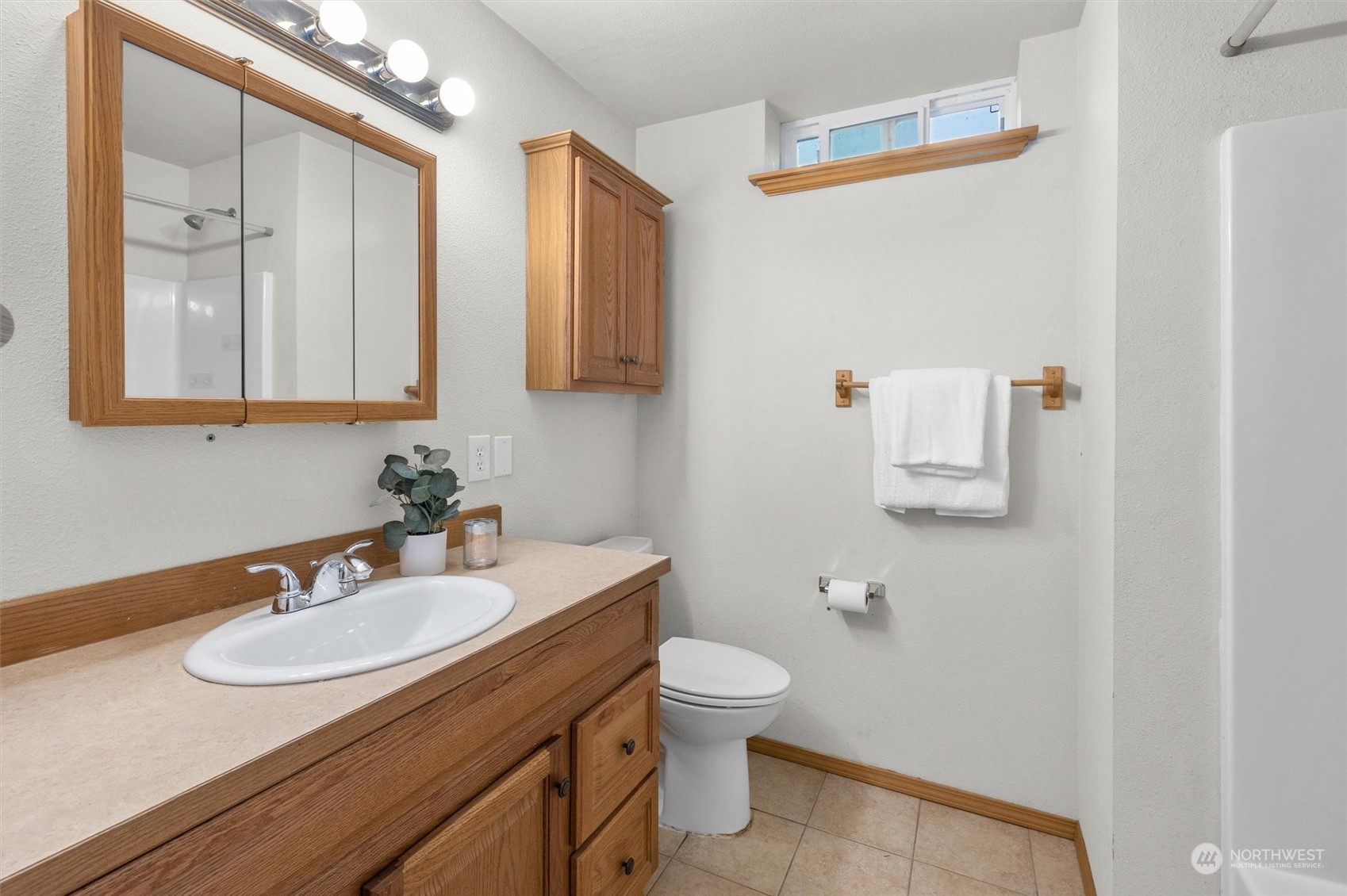 14220 Three Lakes Road Snohomish, WA 98290 - Photo 23 of 31 a bathroom with a sink toilet a mirror and vanity