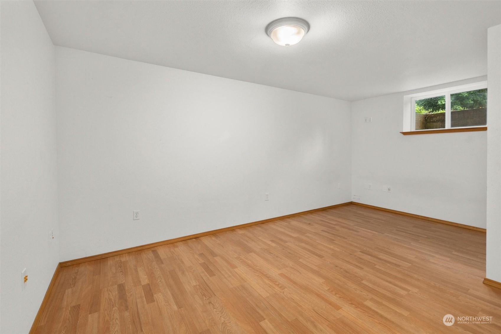 14220 Three Lakes Road Snohomish, WA 98290 - Photo 25 of 31 an empty room with wooden floor and windows