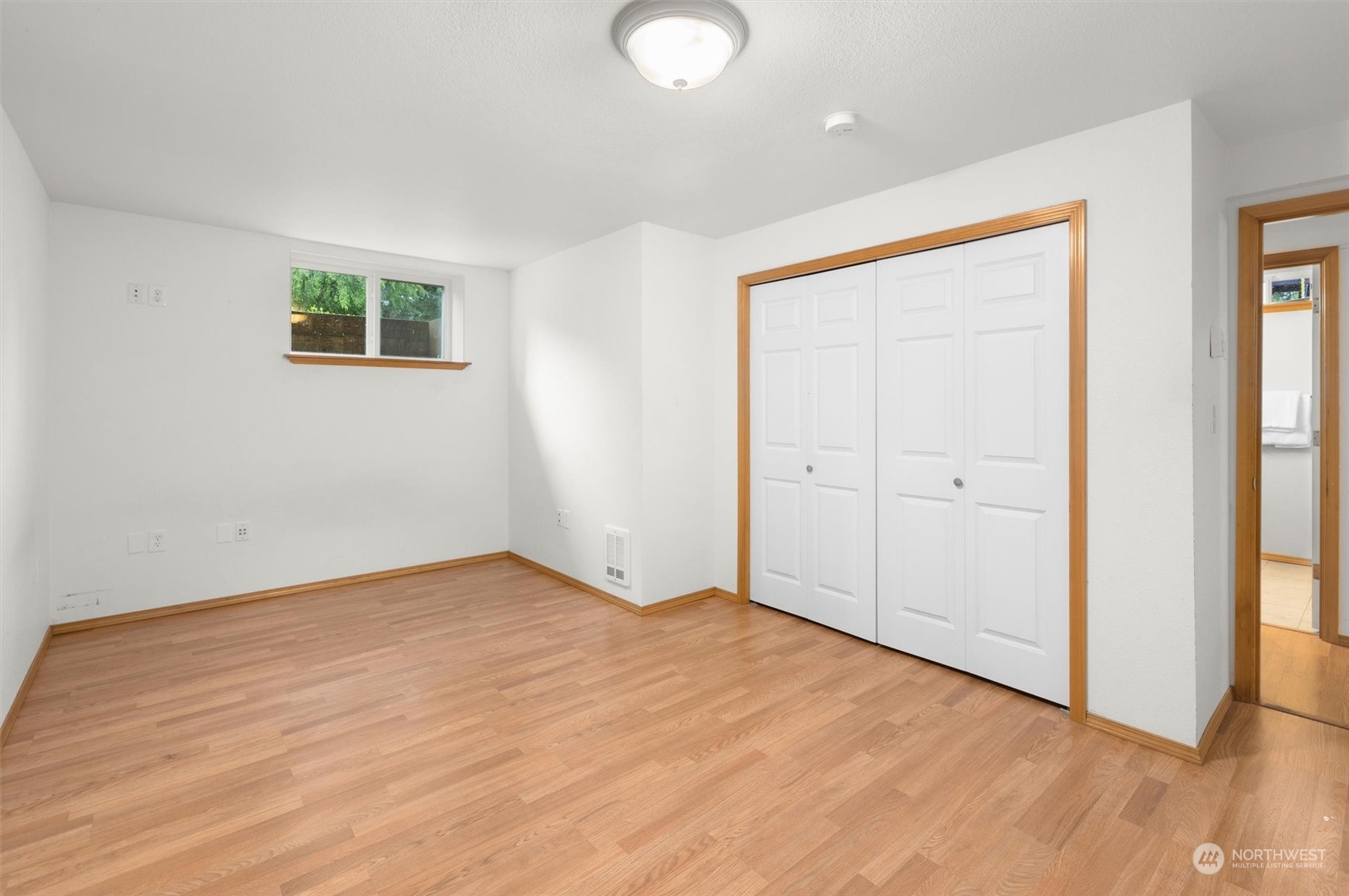 14220 Three Lakes Road Snohomish, WA 98290 - Photo 26 of 31 an empty room with wooden floor and windows