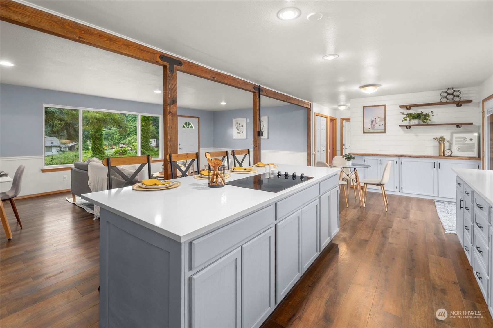 14220 Three Lakes Road Snohomish, WA 98290 - Photo 5 of 31 a large white kitchen with kitchen island a large counter top space a sink a large window and stainless steel appliances
