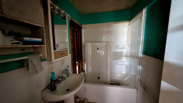 a bathroom with a sink and mirror