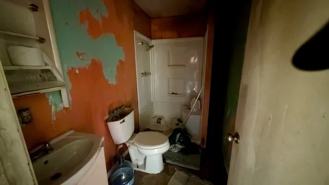 a bathroom with a toilet and a shower
