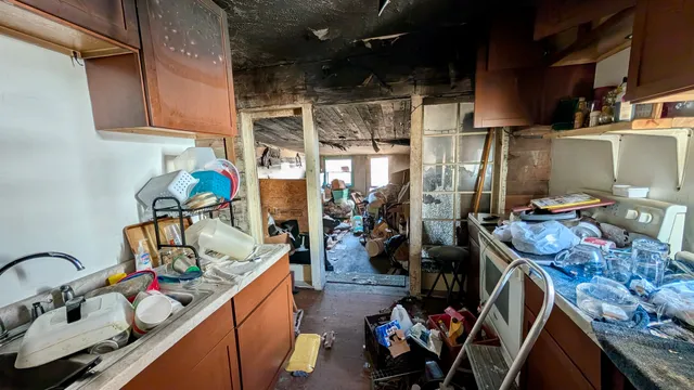 a kitchen with a refrigerator and a stove top oven