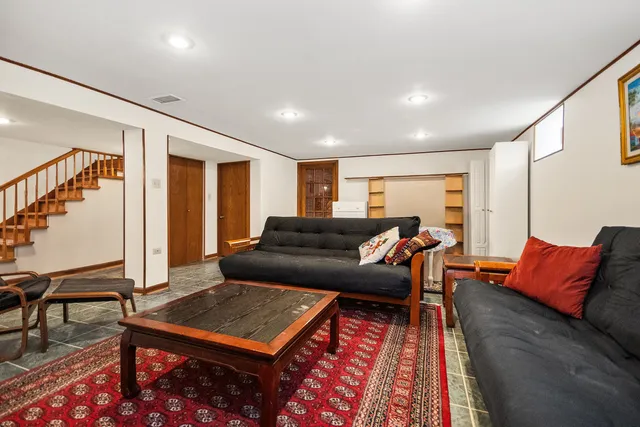 a living room with furniture rug and wooden floor