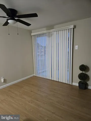 a view of a room with wooden floor