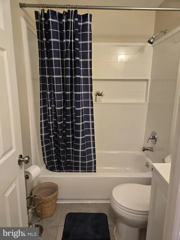 a bathroom with a granite countertop toilet a sink and a shower