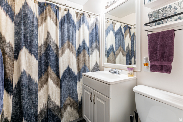 1619 Davis Drive Layton, UT 84041 - Photo 17 of 27 Bathroom featuring a white vanity with integrated sink, a framed mirror, shelves and overhead vanity lighting
