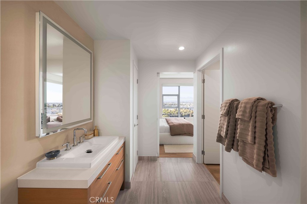 9 Mac Arthur Place, Unit 804 Santa Ana, CA 92707 - Photo 8 of 11 a en suite bathroom with a double vanity sink and mirror