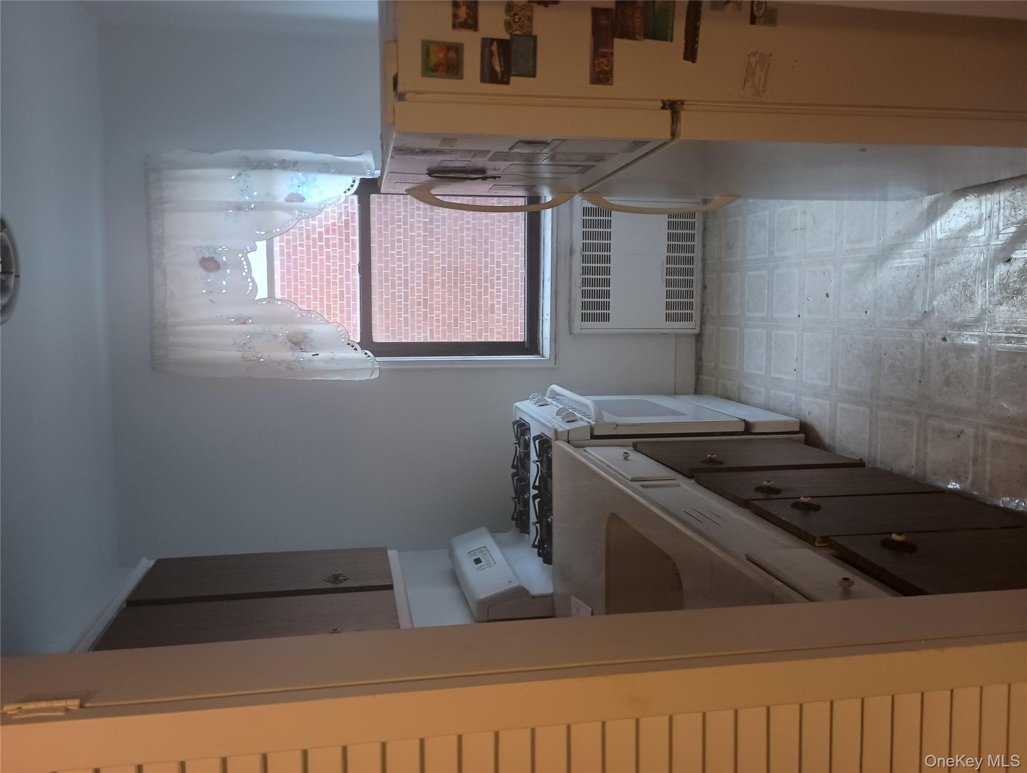 3655 Shore Parkway, Unit 4C Brooklyn, NY 11235 - Photo 3 of 9 a kitchen with a cabinets a stove and a refrigerator