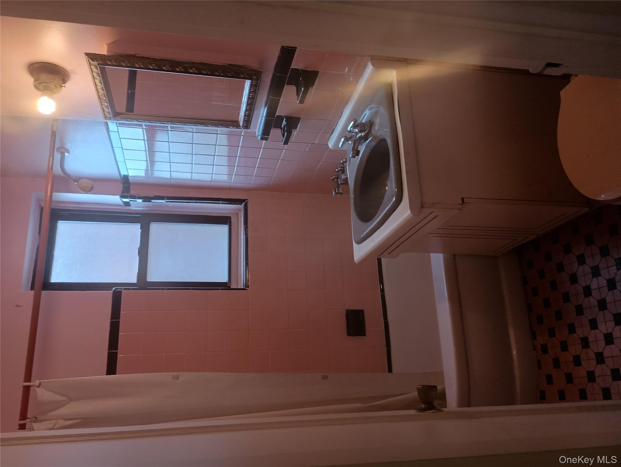 3655 Shore Parkway, Unit 4C Brooklyn, NY 11235 - Photo 6 of 9 a bathroom with a sink toilet and shower