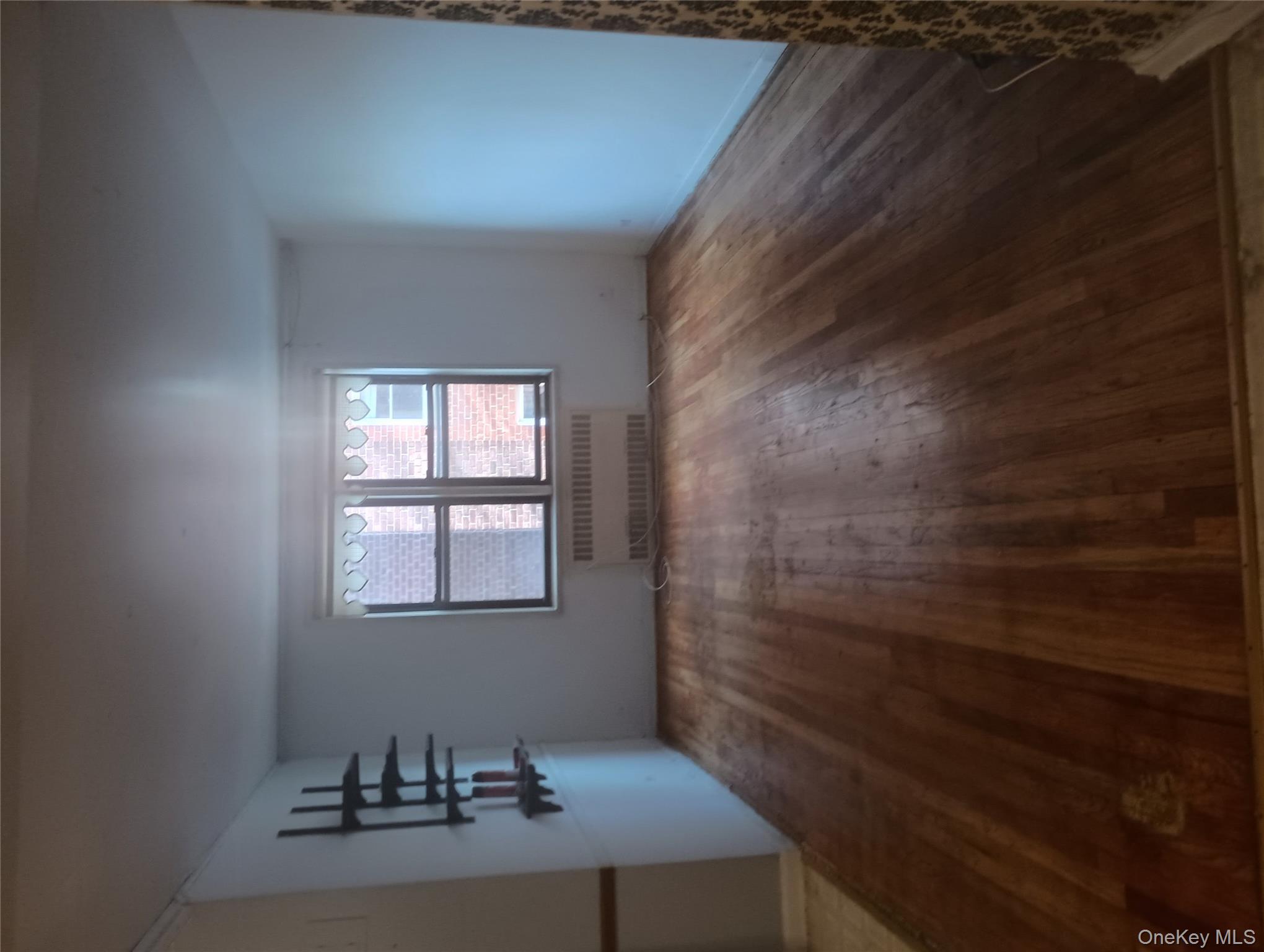 3655 Shore Parkway, Unit 4C Brooklyn, NY 11235 - Photo 7 of 9 wooden floor in an empty room with a window