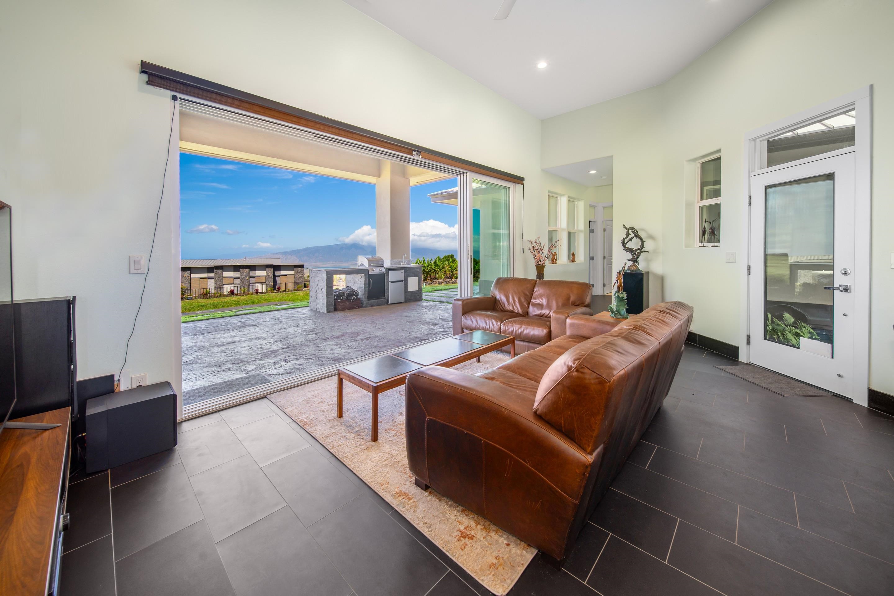 272 Huahua Street Kula, HI 96790 - Photo 12 of 43 a living room with fireplace furniture and a flat screen tv
