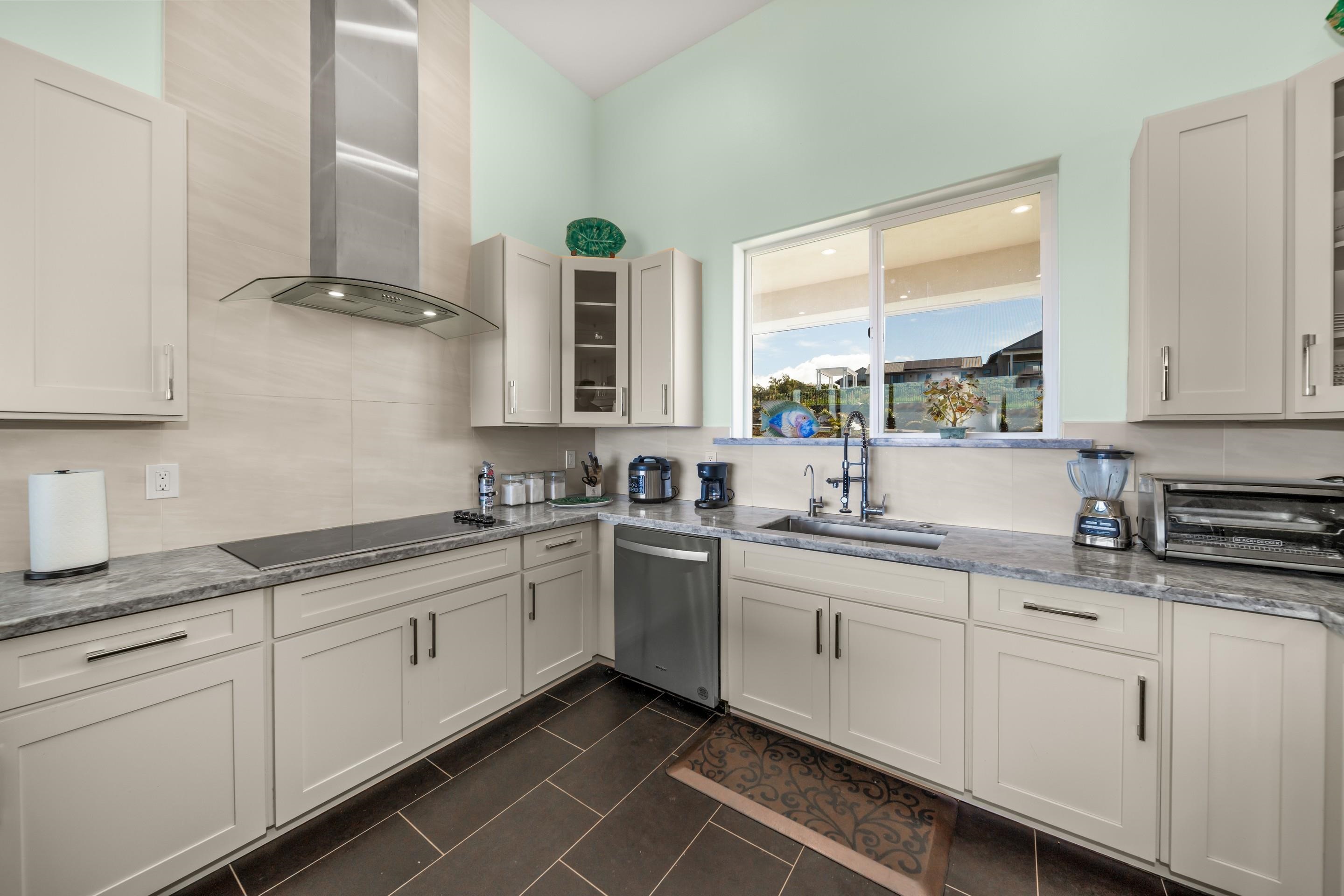 272 Huahua Street Kula, HI 96790 - Photo 15 of 43 a kitchen with sink cabinets and window