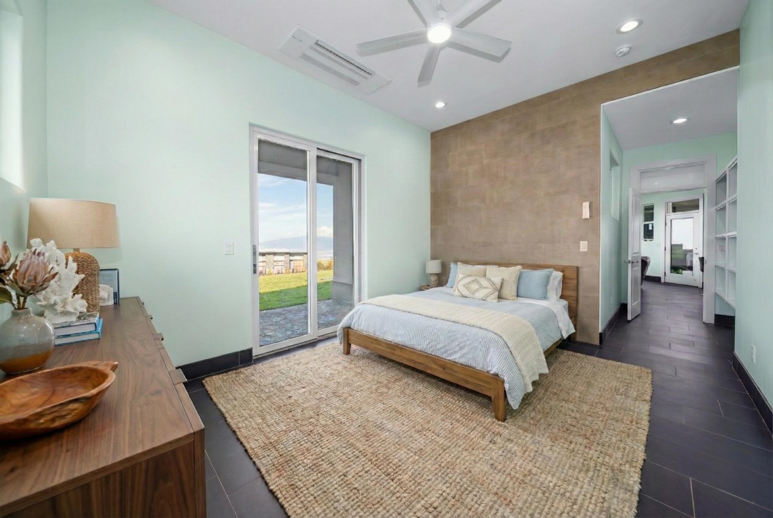 272 Huahua Street Kula, HI 96790 - Photo 17 of 43 a bedroom with a bed and wooden floor