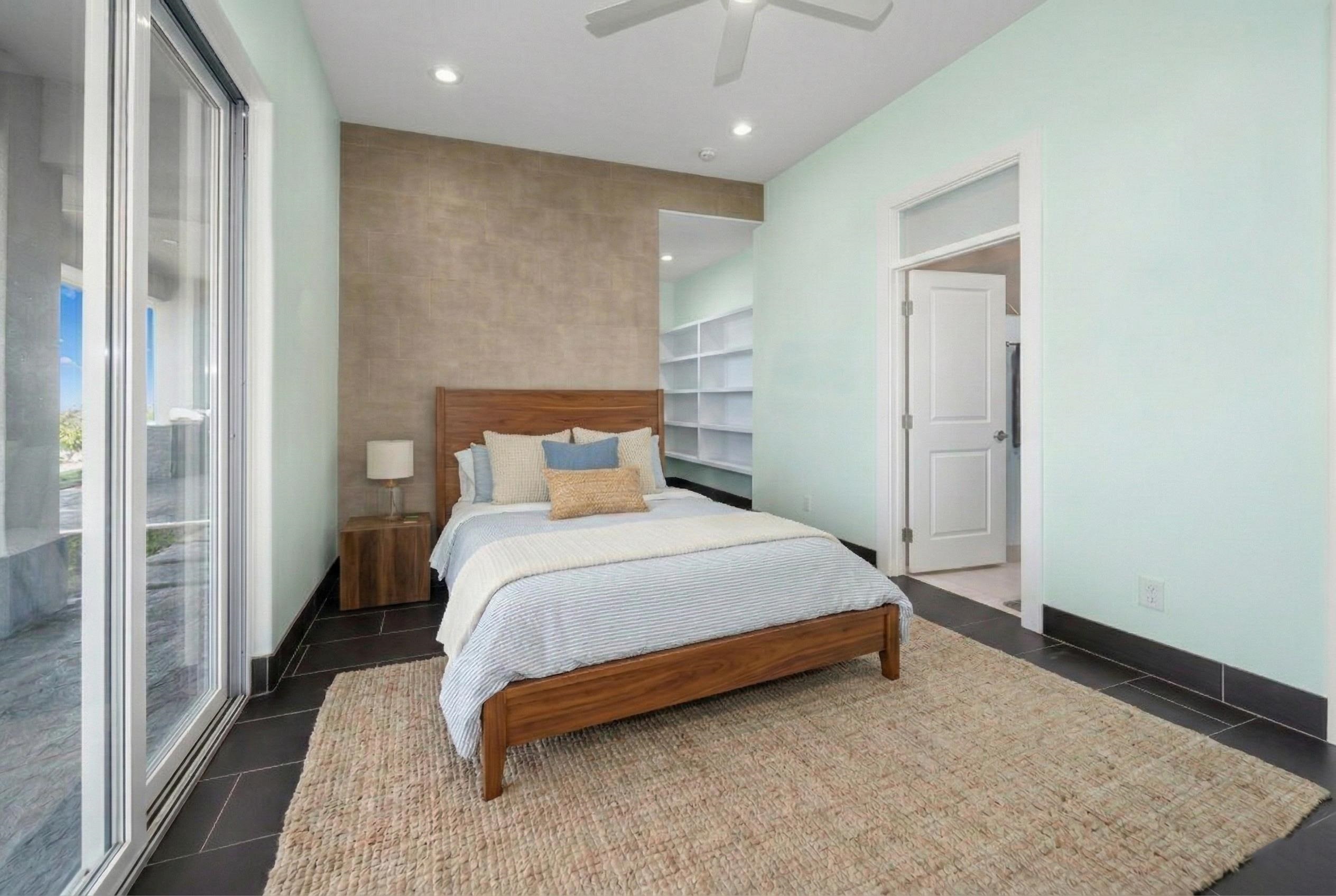 272 Huahua Street Kula, HI 96790 - Photo 18 of 43 a bedroom with a bed and a mirror