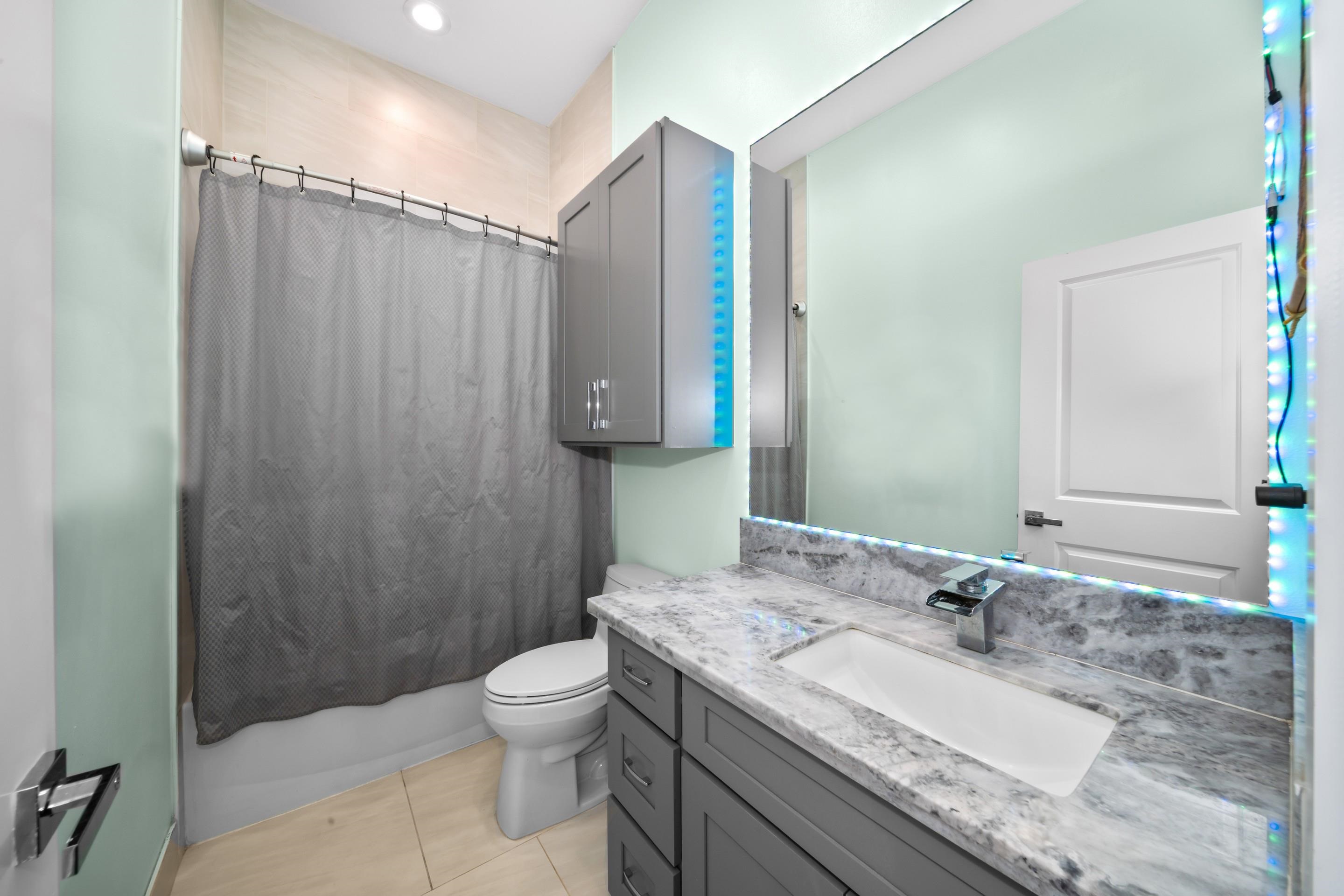 272 Huahua Street Kula, HI 96790 - Photo 20 of 43 a bathroom with a granite countertop sink toilet and shower