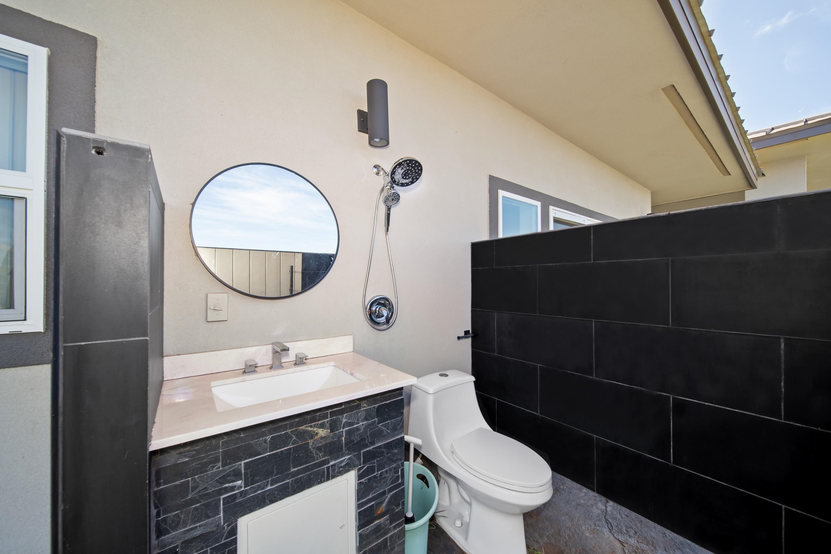 272 Huahua Street Kula, HI 96790 - Photo 31 of 43 a bathroom with a sink a toilet and a mirror