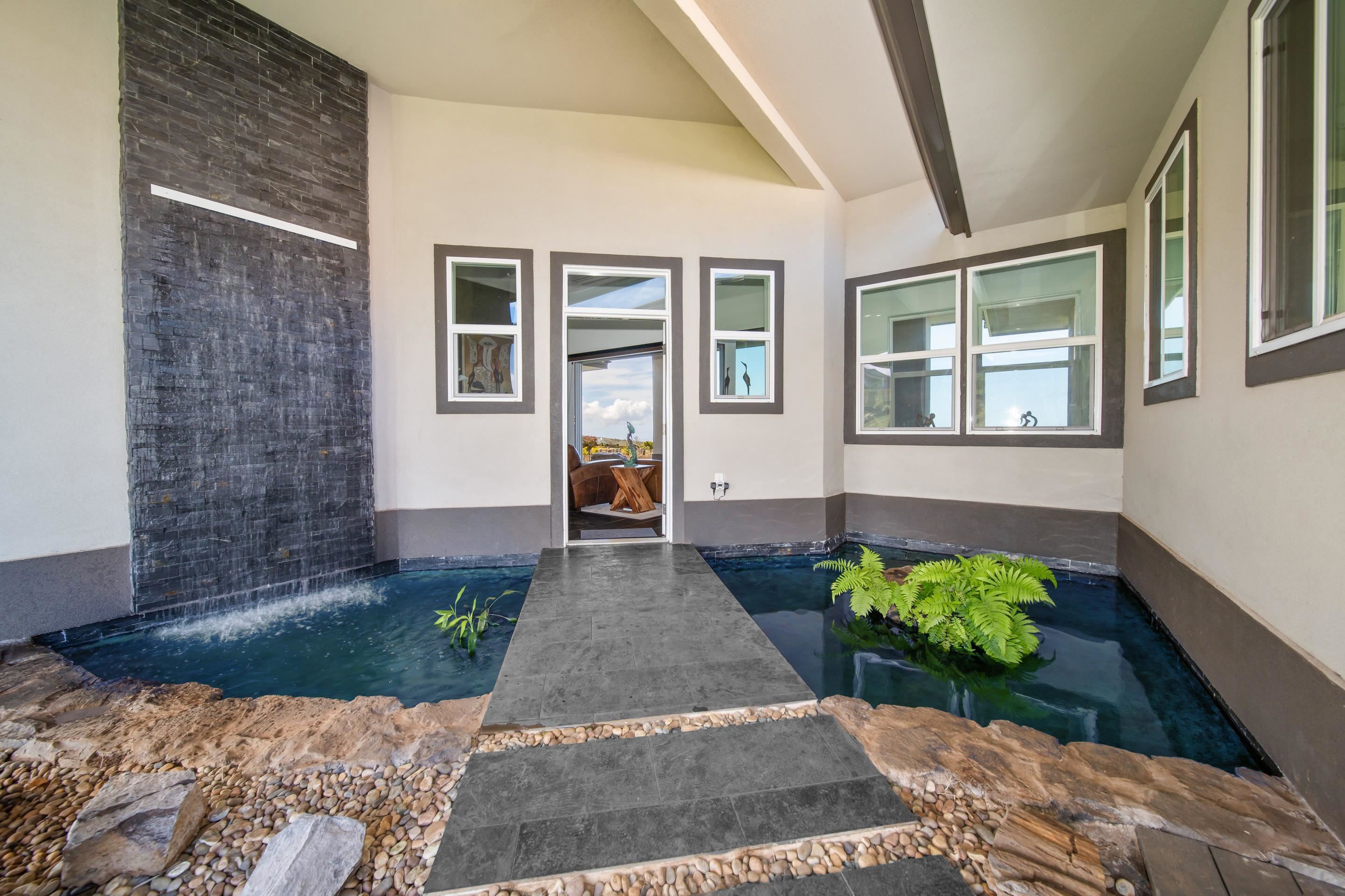 272 Huahua Street Kula, HI 96790 - Photo 8 of 43 a front view of a house with a yard