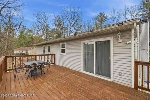 a view of a deck with table and chairs and wooden floor