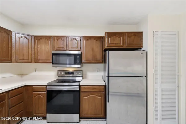 a kitchen with stainless steel appliances a refrigerator sink and microwave