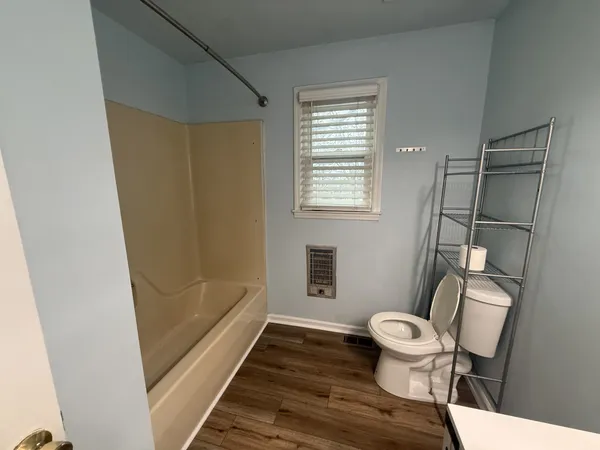 a bathroom with a toilet and a shower