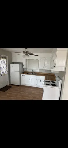 a view of kitchen with white cabinets