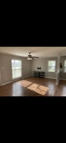 a view of wooden floor and a floor to ceiling window