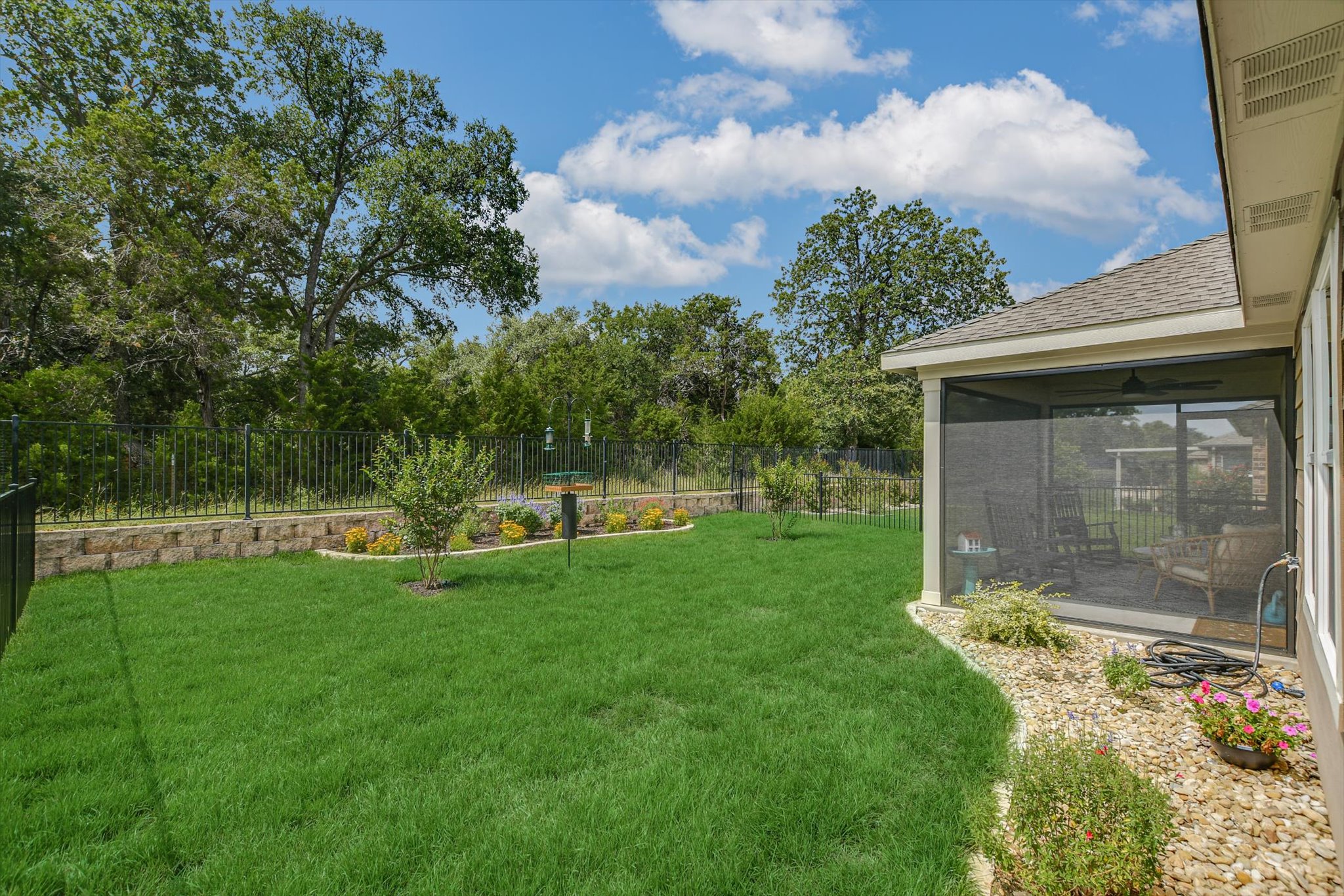 231 Hobby Street Georgetown, TX 78633 - Photo 29 of 29 A pristine backyard oasis features a screened-in porch and manicured lawn.