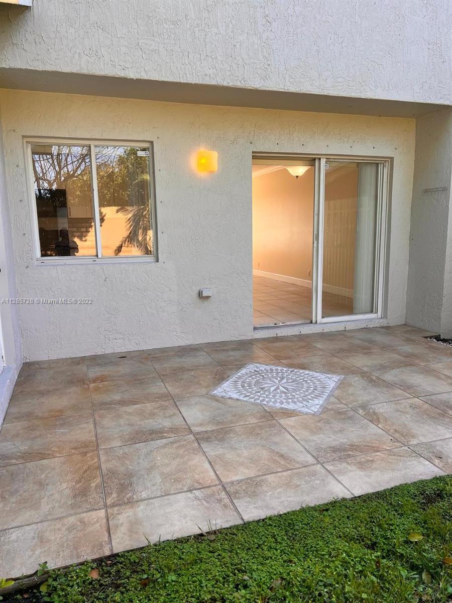 Lakeview Deerfield Beach, FL 33442 - Photo 13 of 14 a front view of a house with a yard