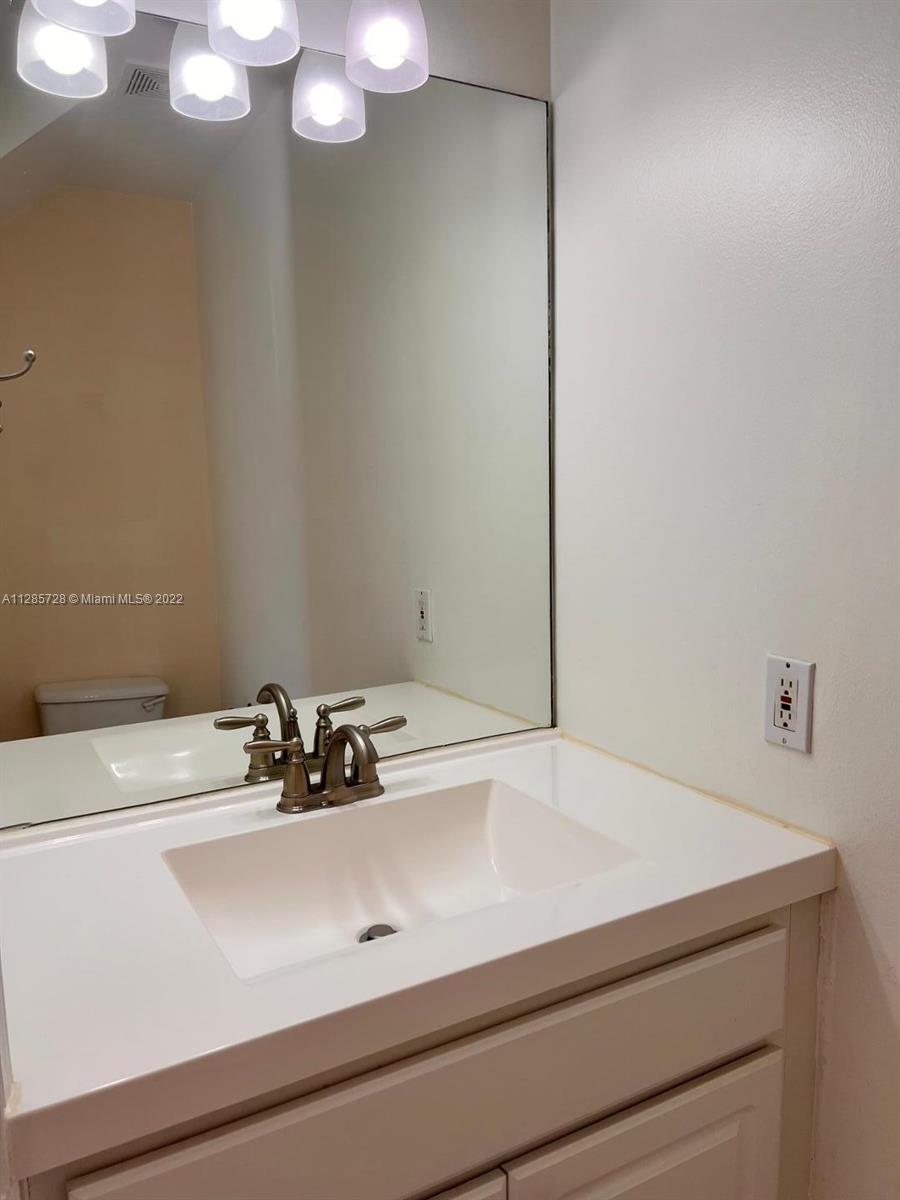 Lakeview Deerfield Beach, FL 33442 - Photo 7 of 14 a bathroom with a sink and a mirror