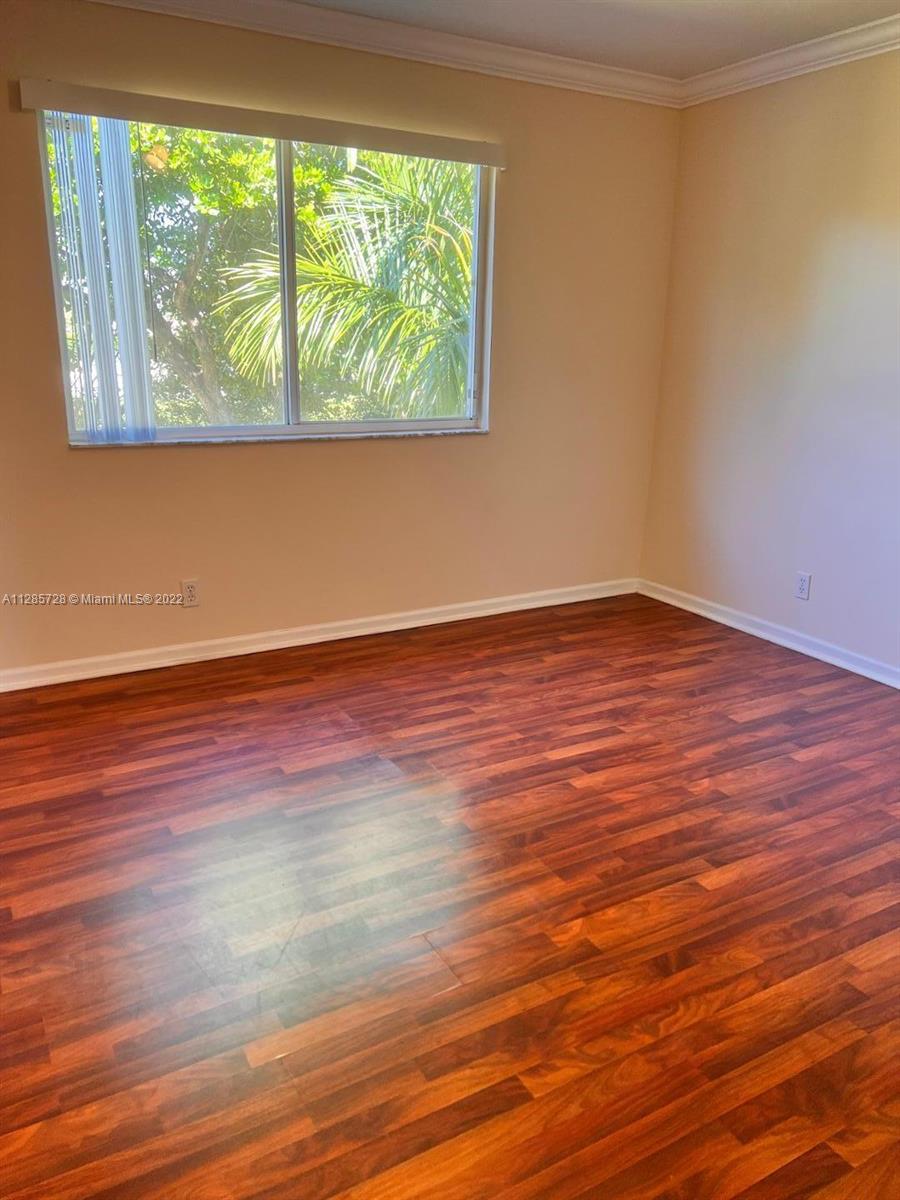 Lakeview Deerfield Beach, FL 33442 - Photo 10 of 14 a view of empty room with wooden floor and fan