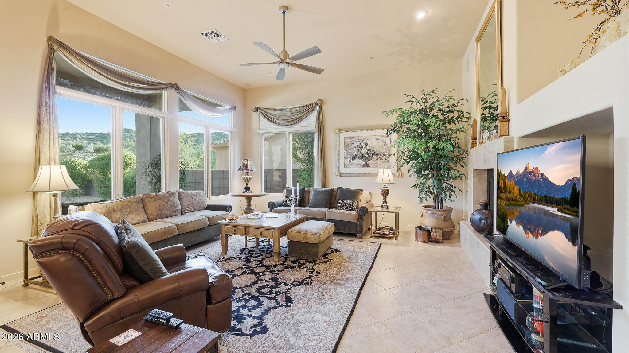 14341 East Geronimo Road Scottsdale, AZ 85259 - Photo 10 of 40 a living room with furniture a chandelier and a flat screen tv