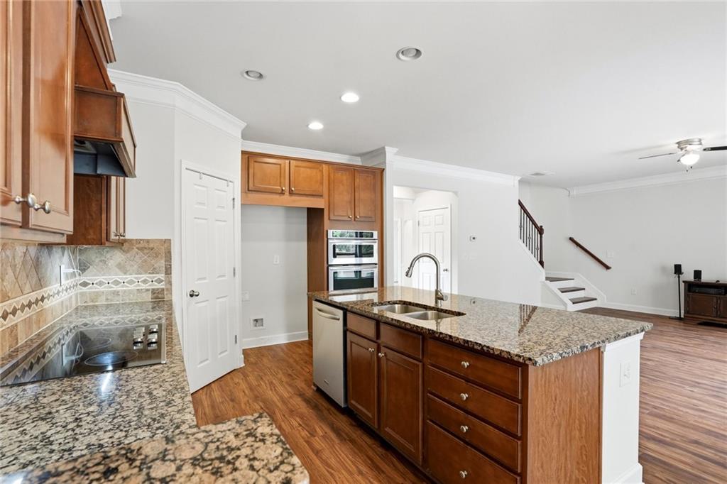 3770 Terrasol Trail Southwest Lilburn, GA 30047 - Photo 12 of 63 a kitchen with stainless steel appliances granite countertop a sink and a stove