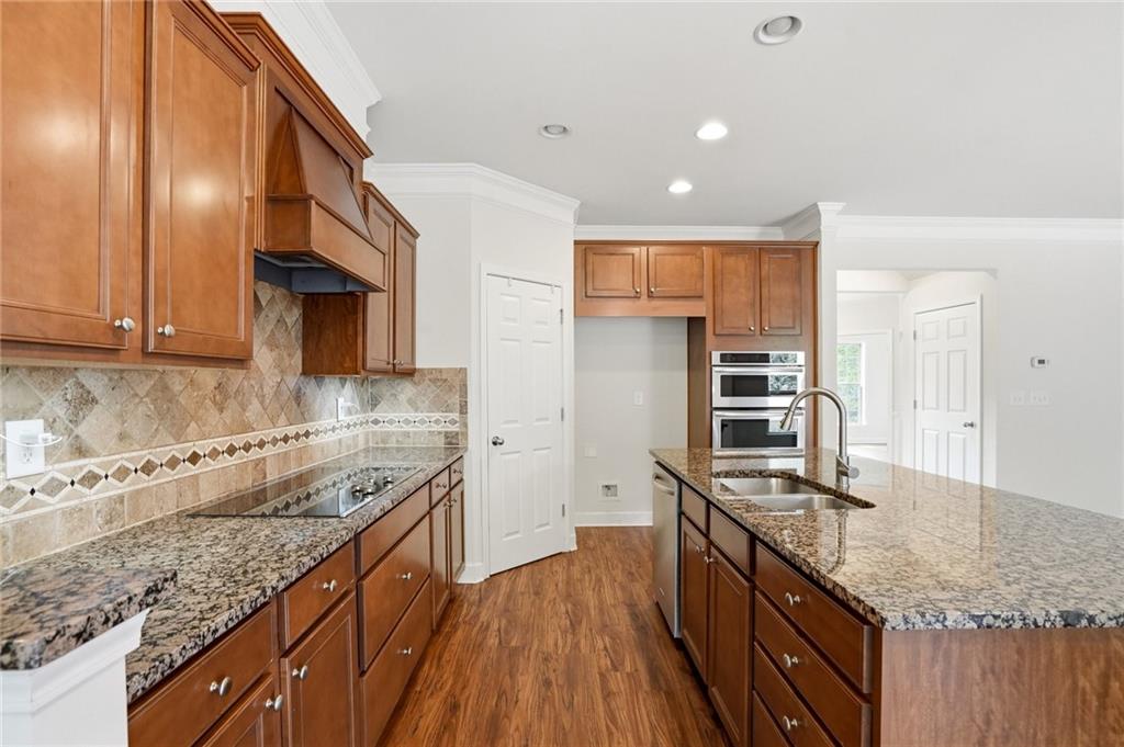 3770 Terrasol Trail Southwest Lilburn, GA 30047 - Photo 14 of 63 a kitchen with stainless steel appliances granite countertop a sink stove and refrigerator