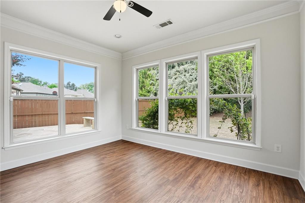 3770 Terrasol Trail Southwest Lilburn, GA 30047 - Photo 16 of 63 a view of an empty room with a window and wooden floor