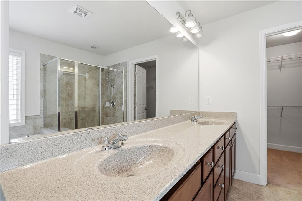 3770 Terrasol Trail Southwest Lilburn, GA 30047 - Photo 25 of 63 a bathroom with a sink a vanity and a mirror
