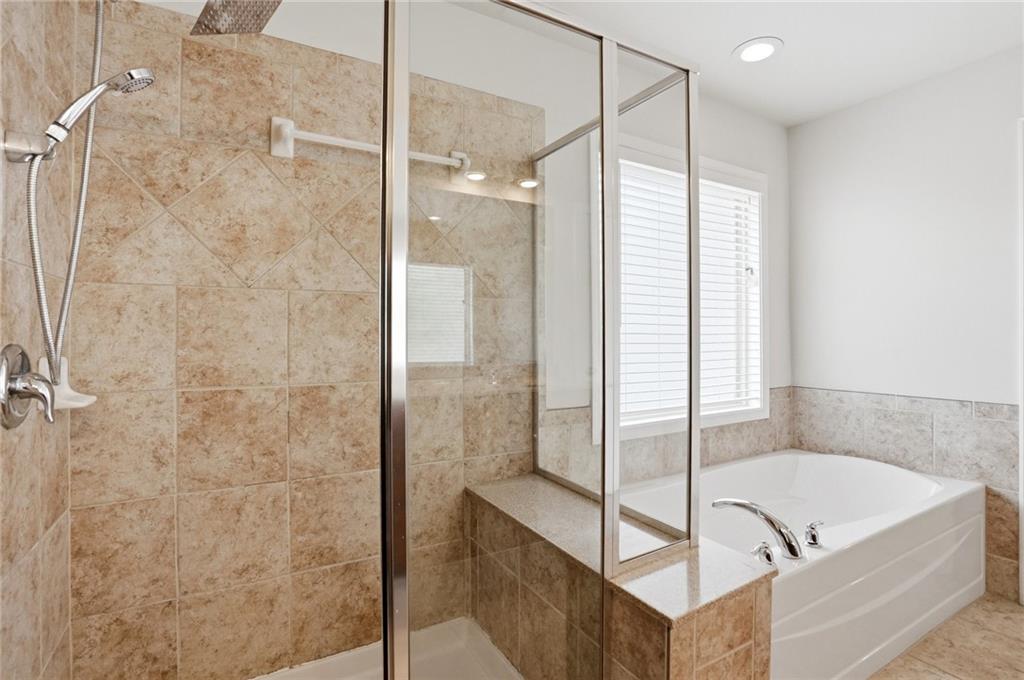 3770 Terrasol Trail Southwest Lilburn, GA 30047 - Photo 26 of 63 a bathroom with a tub shower and sink