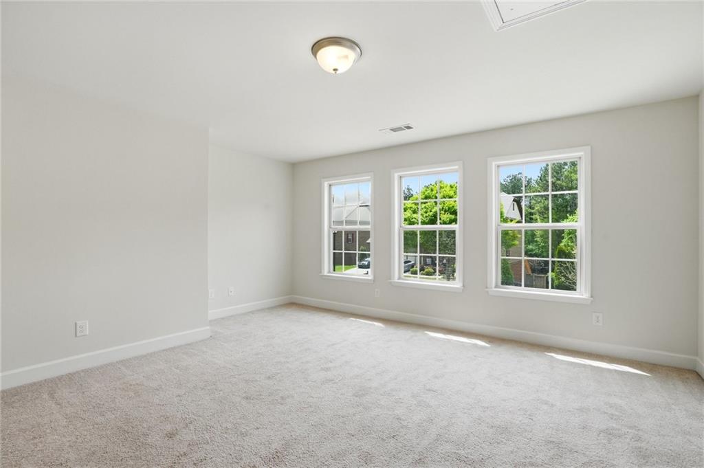 3770 Terrasol Trail Southwest Lilburn, GA 30047 - Photo 29 of 63 an empty room with windows