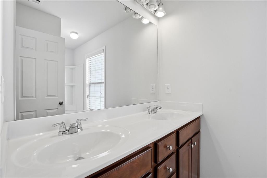 3770 Terrasol Trail Southwest Lilburn, GA 30047 - Photo 33 of 63 a bathroom with a sink and a mirror