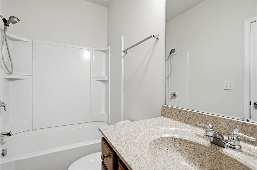 3770 Terrasol Trail Southwest Lilburn, GA 30047 - Photo 38 of 63 a bathroom with a granite countertop sink and a mirror